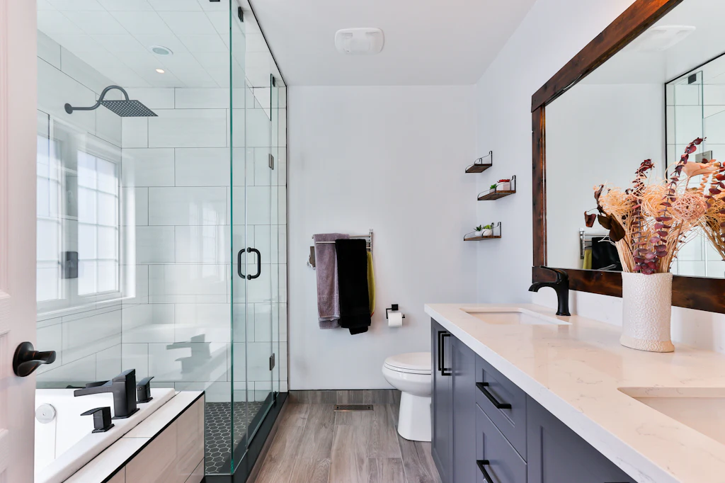 Bright bathroom with a walk-in glass shower and marble vanity